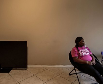 Otishia Harvey sits with her nebulizer at her home in Pahokee.
