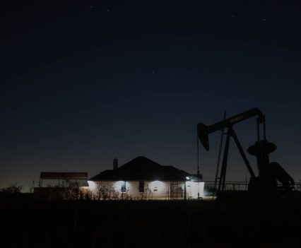 A still pump jack sits beside a home in Midland County, Texas, on Oct. 29, 2021. Oil and gas activity in Midland can often be found close to homes.