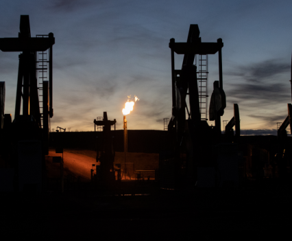 Multi-well oil pads burn natural gas in McKenzie County at sunset on Oct. 29, 2021. The advent of horizontal drilling in North Dakota allowed for multi-well oil pad operations that overwhelmed natural gas pipelines.