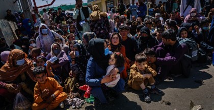 A large group of seated refugees