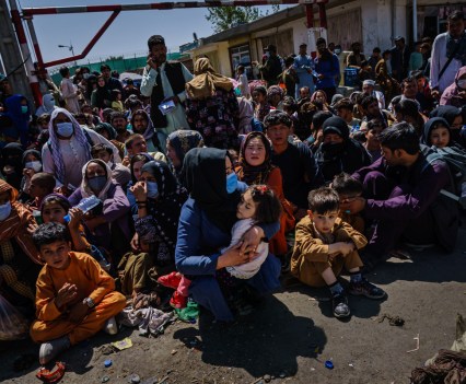 A large group of seated refugees