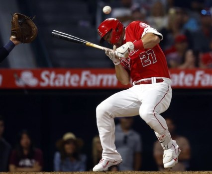 A still of a baseball player at bat missing the ball