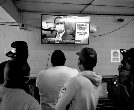 People in Houston watch the verdict in the Derek Chauvin trial on April 20. The convicted former officer was sentenced to more than 20 years in prison, but he will still receive a roughly $1.5 million pension