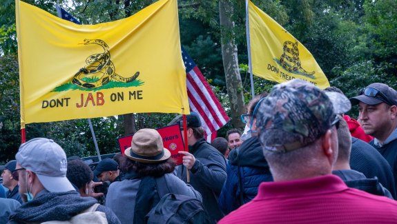 People protest a COVID-19 vaccine mandate for municipal workers on Oct. 28 in New York City. Polling, vaccination and mortality data all suggest that Republicans lag far behind in vaccination and are suffering the worst consequences as a result.