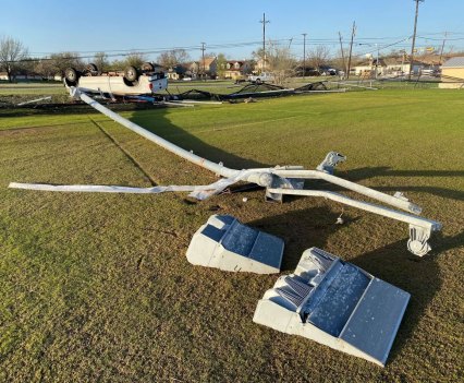 A car is flipped and a lightpole was snapped off its foundation among other damage near the Clay Madsen Recreation Center in Round Rock.