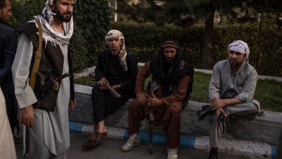 Taliban members in Kabul, Afghanistan, on Sunday. As the militants moved into the capital, police posts were abandoned and posters of women at beauty salons were painted over