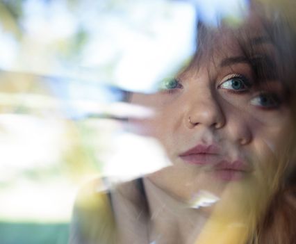 A distorted photo of a young woman's face