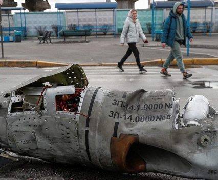 People walk past the remains of a missile at a bus terminal in Kyiv, Ukraine March 4, 2022.