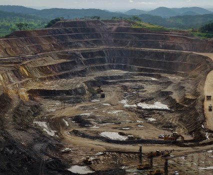 Excavators and drillers work in an open pit at Tenke Fungurume, a copper and cobalt mine