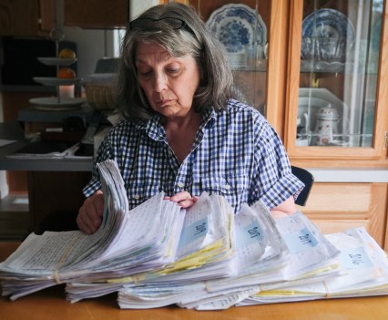 Susan Ottele looks through hundreds of handwritten letters that her son, Adam Collier, mailed to her from prison between 2016 and 2020.