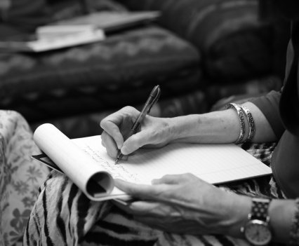 Baldwin takes notes during her June 2022 interview with Earline Floyd.