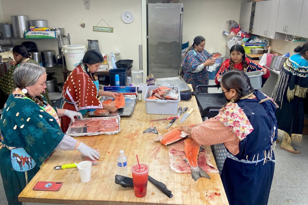 Lottie Sam, front right, and other women prepare salmon in Toppenish, Washington, before a ceremony held by the Confederated Tribes and Bands of the Yakama Nation.