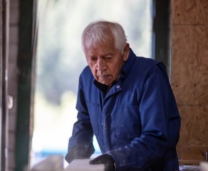 Mr. Retasket cuts white pine for a drum in one of his workshops.