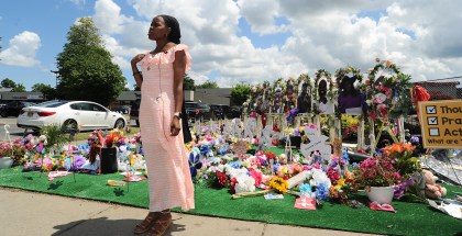 BUFFALO, NY - JULY 14: Fragrance Harris Stanfield, assistant customer service representative at the Tops Friendly Market on Jefferson Avenue, is interviewed at a "Memorial Garden" filled with flowers, photos and mementos outside the store on July 14, 2022 in Buffalo, New York. The store was the scene of a mass shooting on May 14, 2022 when accused shooter Payton Gendron killed 10 Black people and injured three others in what is believed to be a racially-motivated attack. The market will reopen to the public Friday after extensive renovations to the building. (Photo by John Normile/Getty Images)