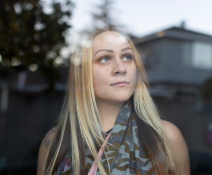 LOS ANGELES, CA - DECEMBER 18, 2022: Sarah Fay is pictured looking out the window of her Grandmothers living room in Culver City December 19, 2022. Sarah’s problem is that she can’t find a place she can afford with a landlord that will take her even though she has a full-time job. She earns nearly $4K per month, but after years living between her car, at hotels, her mother’s place, and Grandmothers garage she doesn’t seem to be the ideal tenant to landlords and lives a life of housing insecurity at 28 years old. (Photo by Barbara Davidson)