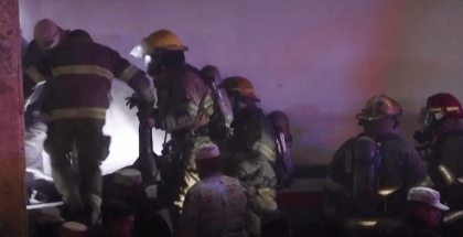 Firefighters pulling bodies from the fire