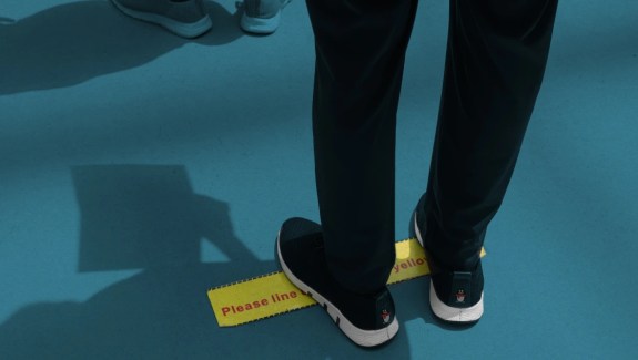 Illustration of feet standing on a yellow line