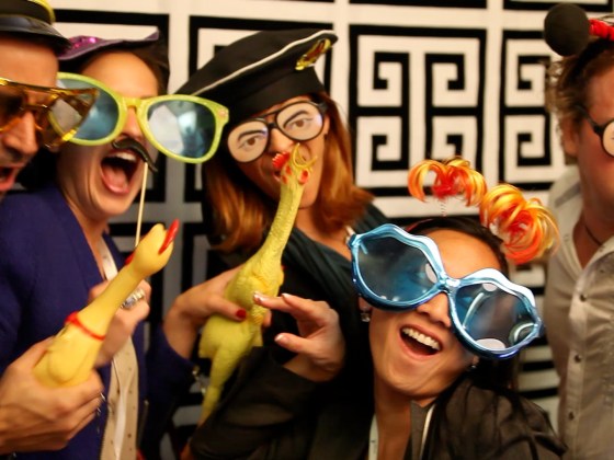 Image: Attendees at ONA's opening reception smile for a photo booth camera at the Rincon Center in San Francisco Thursday night. (Photo by Jill Knight)