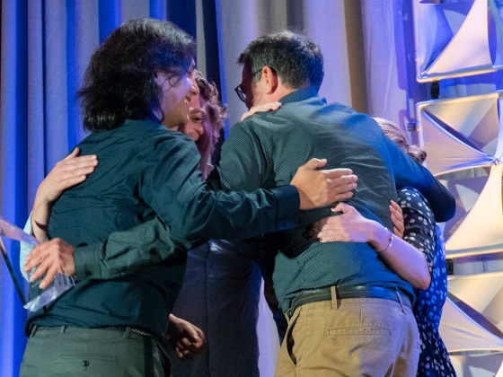 Journalists from Trint share a group hug after winning an OJA. (Photo: Violet Wang)