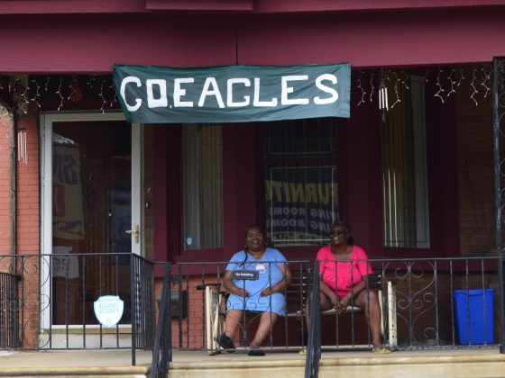 Eagles Fans celebrate the team on the porch of their row home.