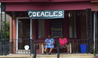 Eagles Fans celebrate the team on the porch of their row home.