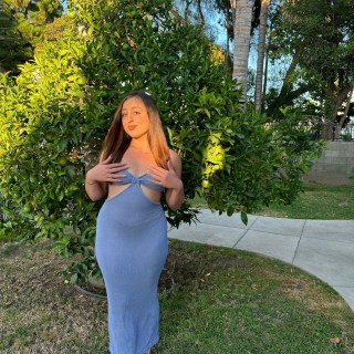 Girl in front of tree.