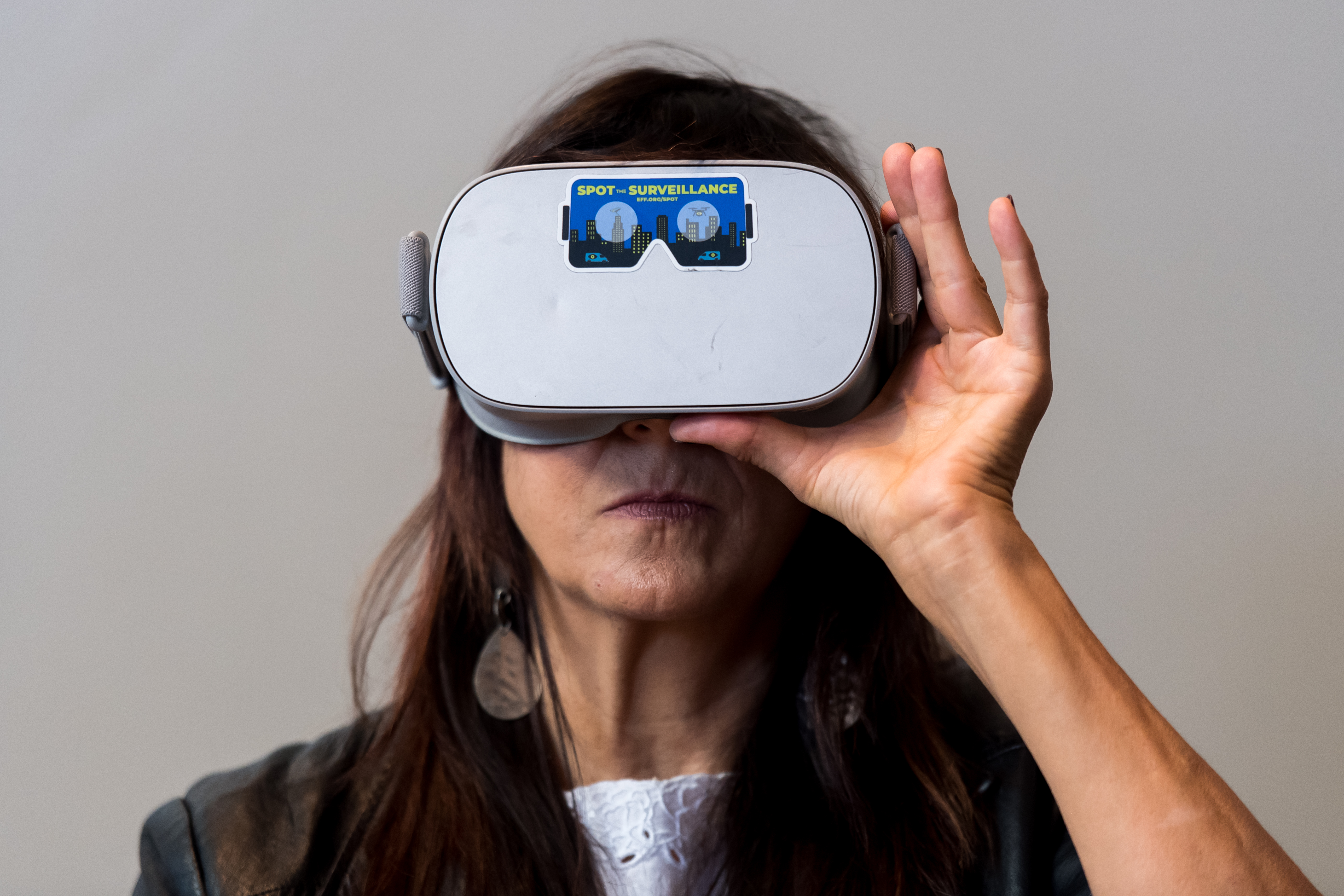 An attendee at the Journalism 360 Immersive Storytelling Festival is experiencing Electronic Frontier Foundation's Spot the Surveillance project through a virtual reality headset.